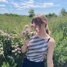 Enora holding a bouquet of bee balm